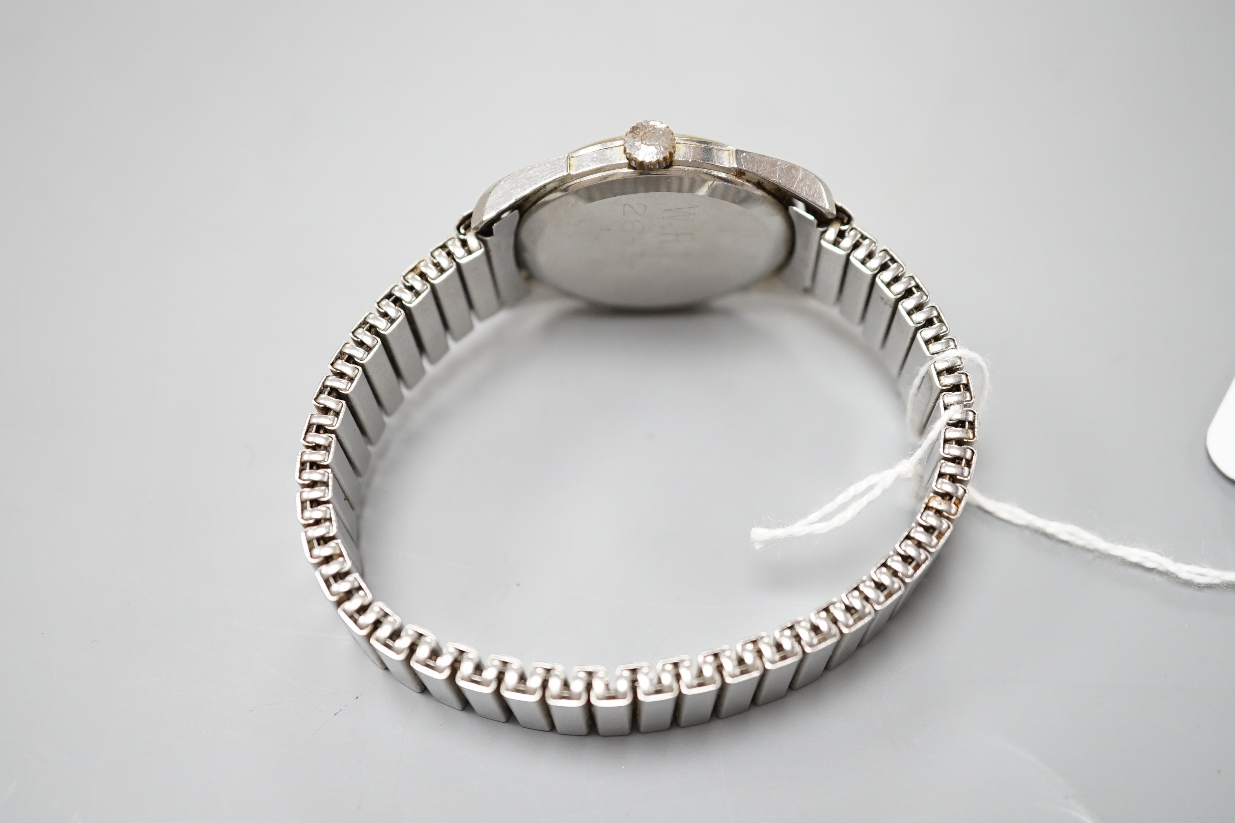 A gentleman's stainless steel Omega manual wind wrist watch, with Arabic dial and case back inscription, on associated flexible bracelet, case diameter 35mm.